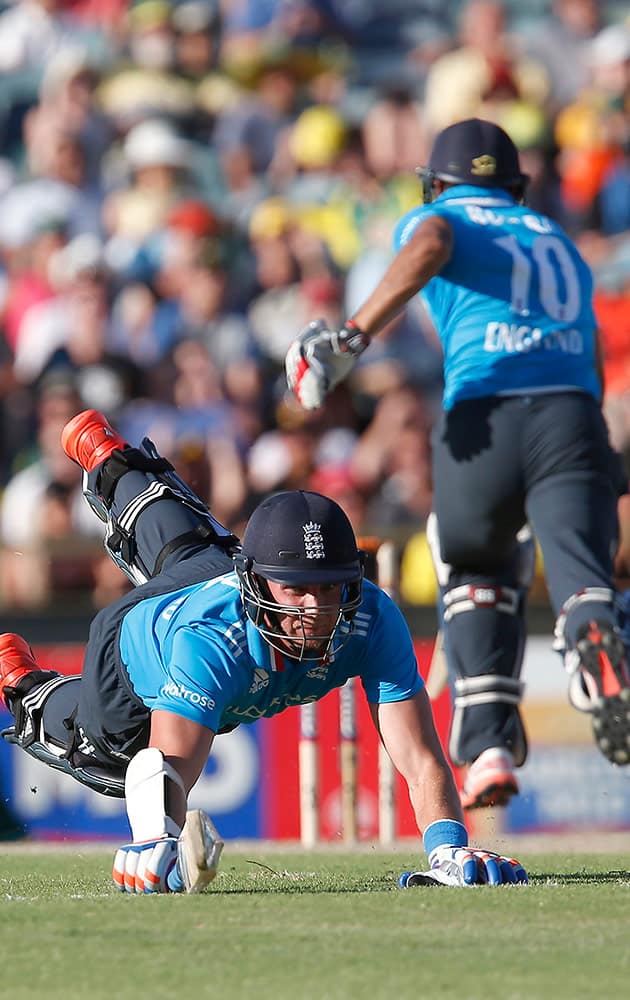 England's Stuart Broad, left, dives to make his crease during their one day international cricket match against Australia in Perth, Australia.