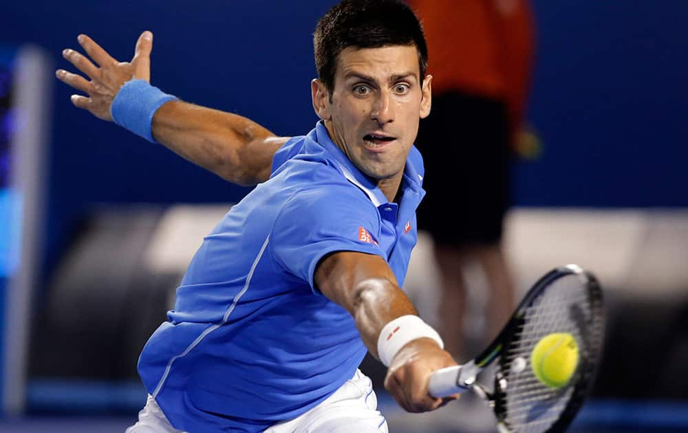 Novak Djokovic of Serbia makes a backhand return to Andy Murray of Britain during the men's singles final at the Australian Open tennis championship in Melbourne, Australia.