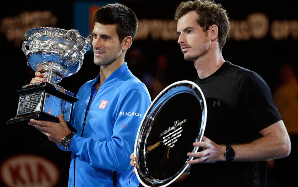 Novak Djokovic of Serbia, left, holds the trophy with runner-up Andy Murray of Britain during the trophy presentation after winning their men's singles final at the Australian Open tennis championship in Melbourne, Australia, Sunday.