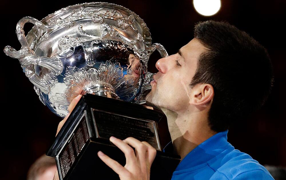 Novak Djokovic of Serbia kisses the trophy after defeating Andy Murray of Britain in during the men's singles final at the Australian Open tennis championship in Melbourne, Australia.