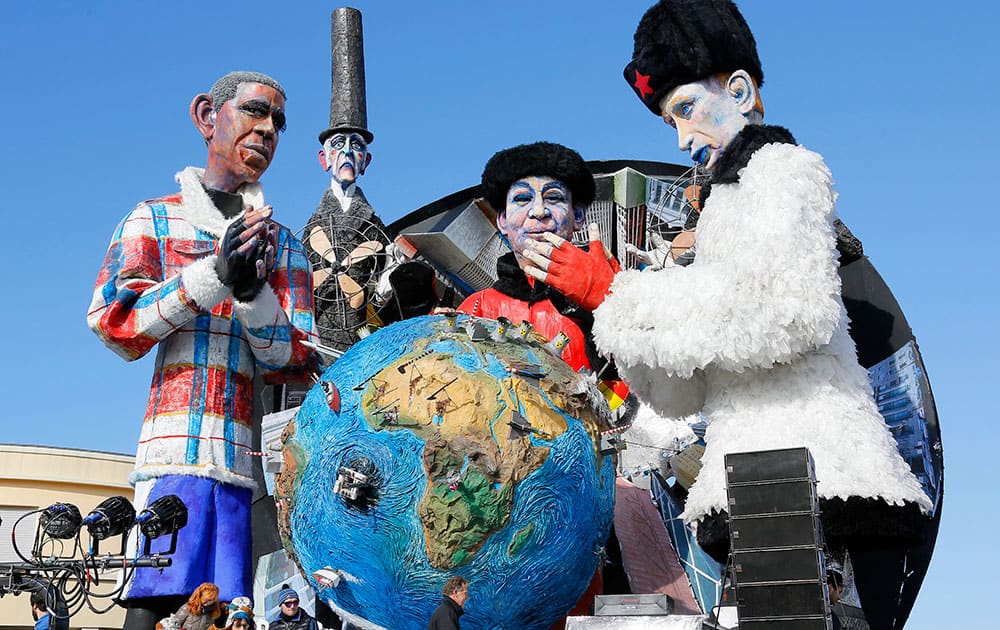 A float depicting United States President Barack Obama, left, Chinese President Xi Jinping, center, and Russian President Vladimir Putin and entitled 