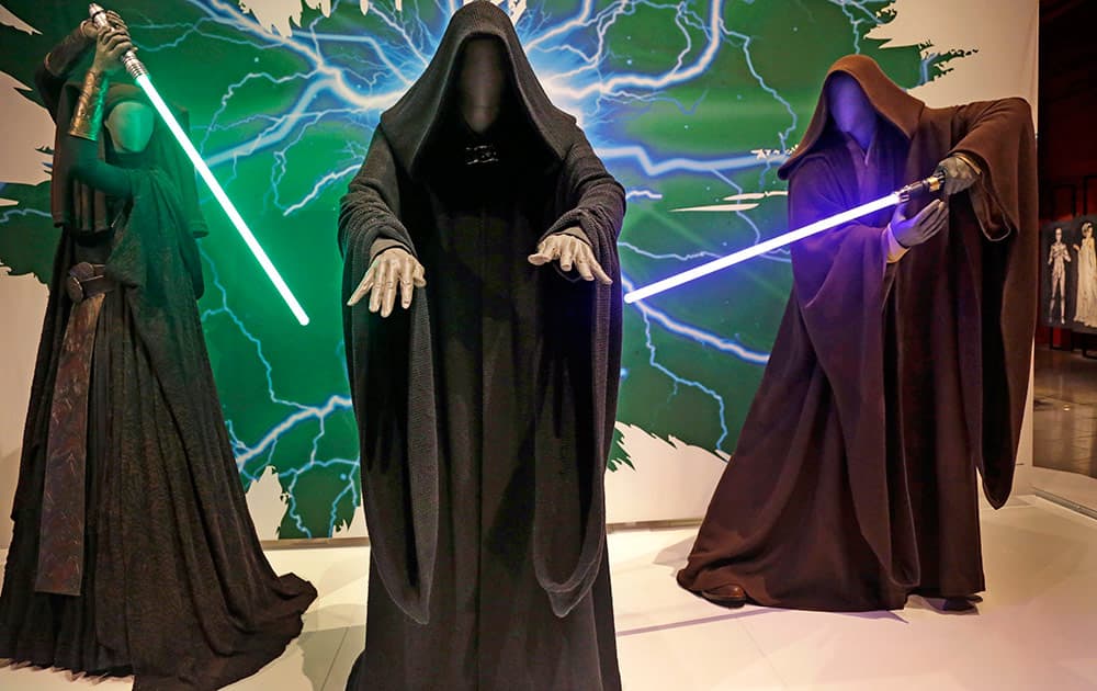 Sith robes and lightsabers are displayed as part of an exhibit on the costumes of Star Wars at Seattle’s EMP Museum.
