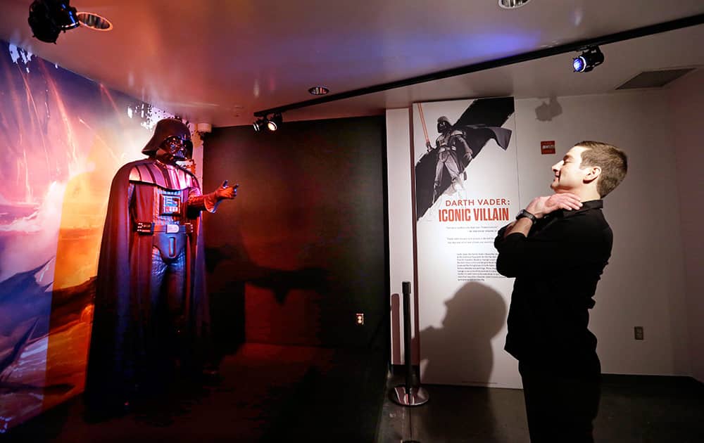 Project director Saul Drake stands-in where visitors are likely to want their photo taken in front of a Darth Vader costume on display as part of an exhibit on the costumes of Star Wars at Seattle’s EMP Museum.