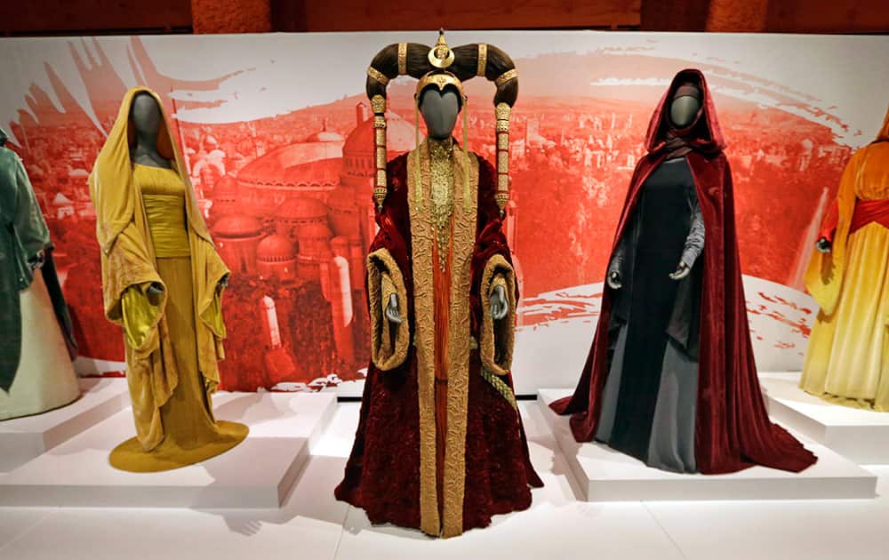 The Senate gown of Queen Amidala, center, is seen with handmaiden gowns on display as part of an exhibit on the costumes of Star Wars at Seattle’s EMP Museum.