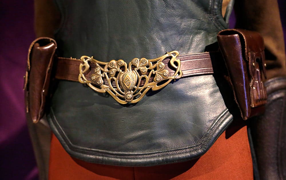 The emblem of a Naboo starfighter pilot is seen on the belt of a Padme Amidala costume displayed as part of an exhibit on the costumes of Star Wars at Seattle’s EMP Museum.