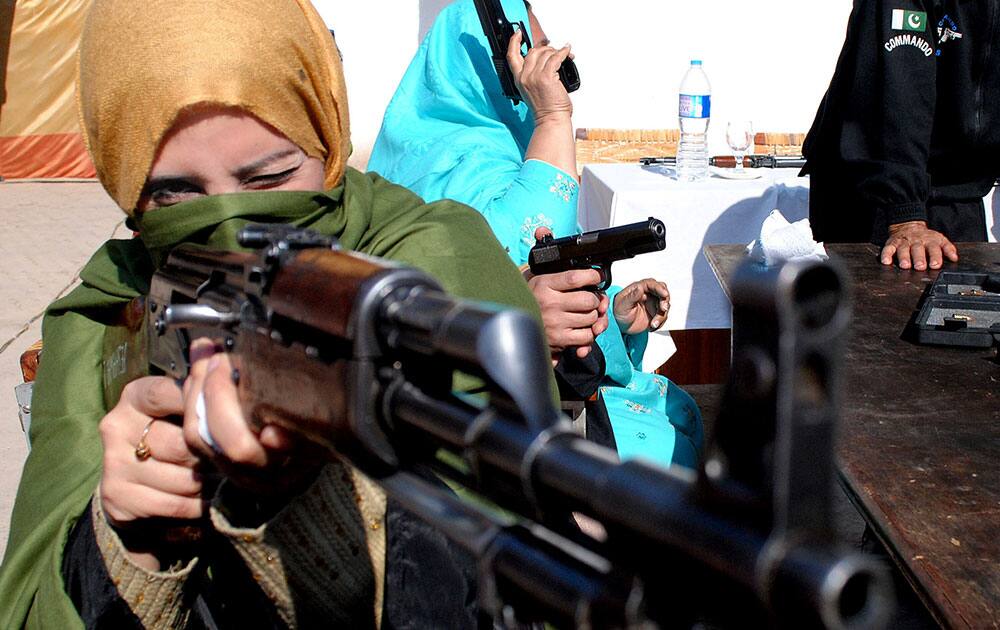 A Pakistani teacher holds an weapon during a two-day training session by the police in Peshawar Pakistan. When Pakistani Taliban militants stormed a Peshawar school on Dec. 16, 2014 and massacred 150 children and teachers, nobody could fight back.