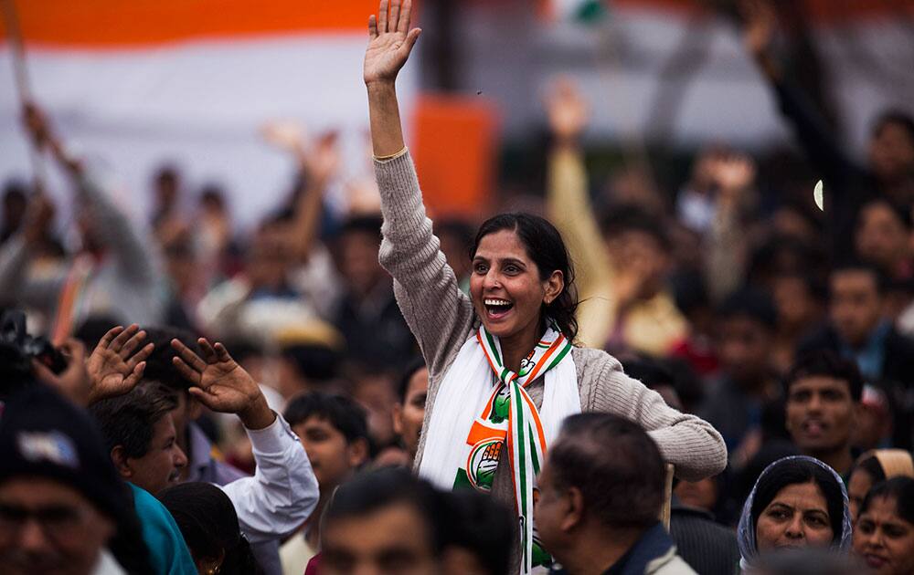 A supporter waves to Congress party president Sonia Gandhi, during a campaign rally ahead of Delhi state elections in New Delhi