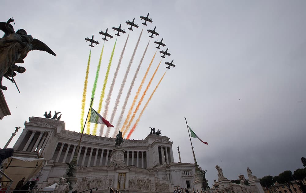 The Frecce Tricolori (three-color arrows) Italian Air Force acrobatic squad fly above the Vittoriano Unknown Soldier monument as newly elected Italian President Sergio Mattarella lays a wreath, in Rome, Tuesday.