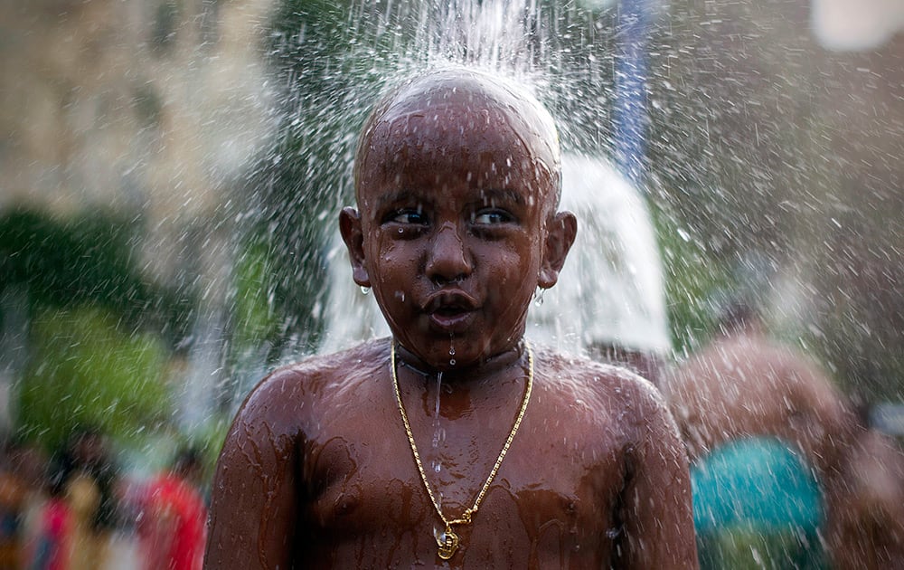 A Hindu devotee gets showered as part of a cleaning ritual before his pilgrimage during the Thaipusam festival in Kuala Lumpur, Malaysia.