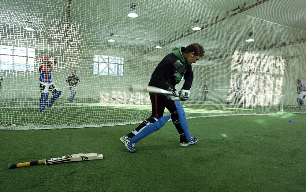 Afghan cricket player Nasir Ahmadzai practices at Kabul cricket academy training center, in Kabul, Afghanistan.