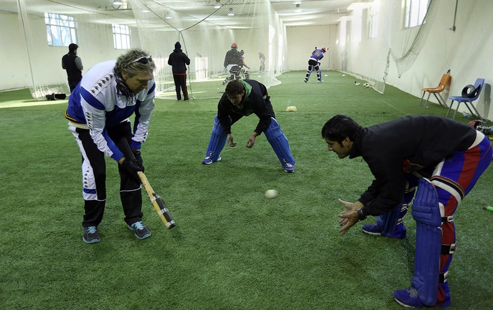 Peter Anderson, coach of Afghan National Cricket team, practices with players at the Kabul cricket academy training center, in Kabul, Afghanistan.