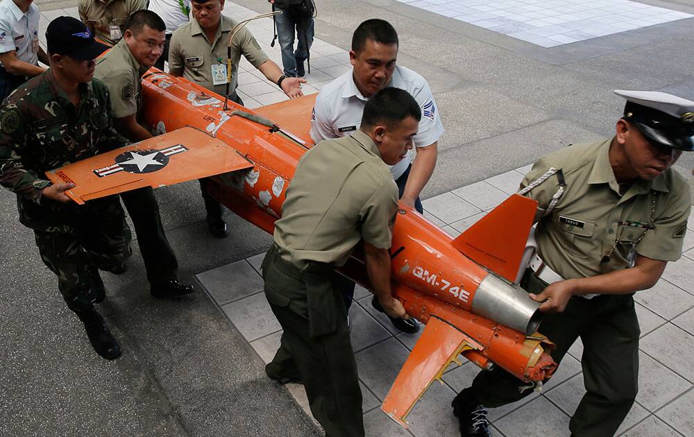 Soldiers carry a U.S. Navy target drone for presentation to the media at the Armed Forces of the Philippines headquarters at Camp Aguinaldo in suburban Quezon city, northeast of Manila, Philippines. 