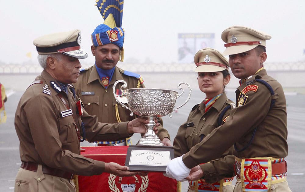 CRPF DG Prakash Mishra awarding the Best trainees award to Pooja & Jagtap Vinayak Sadashiv during a passing out parade at CRPF Academy Kadarpur in Gurgaon.