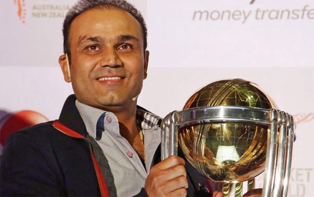 Virender Sehwag poses with the World Cup Trophy at a promotional event, Mumbai.