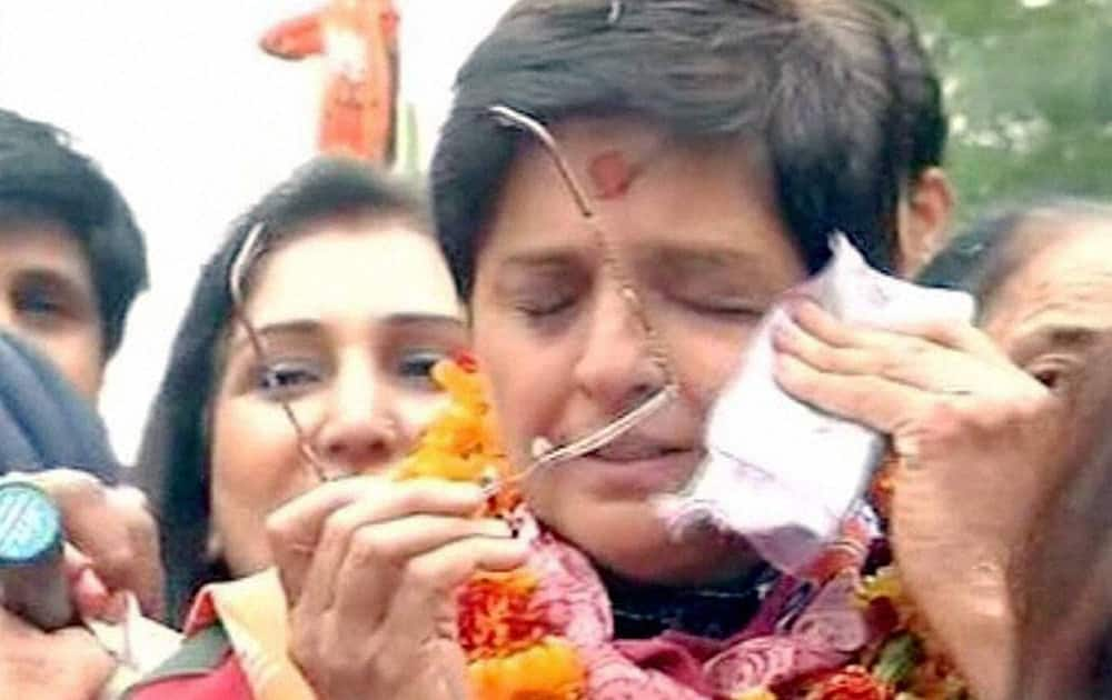 A video grab of BJPs chief ministerial candidate Kiran Bedi wiping her tears during a road show in New Delhi.