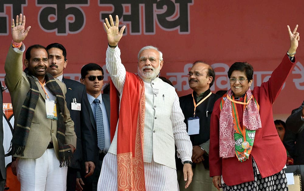 Prime Minister Narendra Mod and BJP CM candidate Kiran Bedi at an election rally at Ambedkar Nagar in New Delhi.