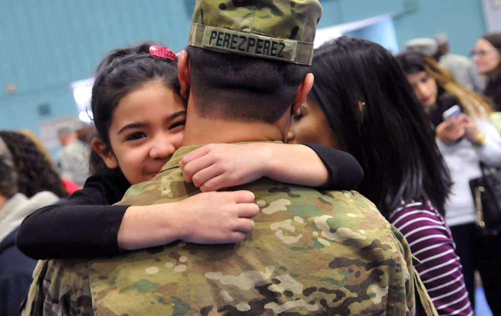 Sgt. Angel Perez Perez hugs his daughter Katelyn, 3, during a deployment ceremony at Fort Lee, Va. Troops from the Army's 54th Quartmaster Company are set to deploy to Afghanistan and Kuwait for six months later this week. 