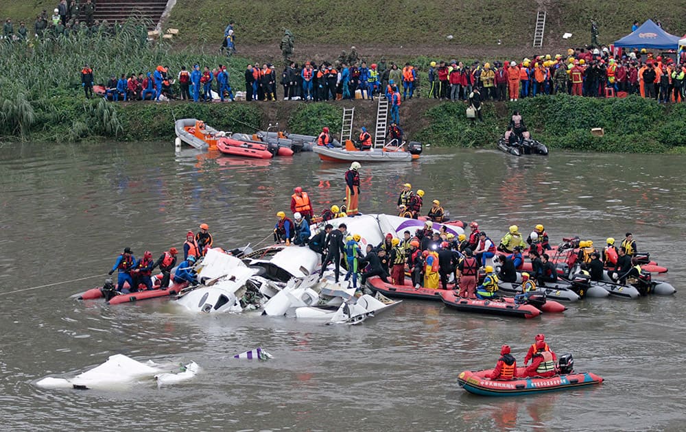 Emergency personnel try to extract passengers from a commercial plane after it crashed in Taipei, Taiwan.