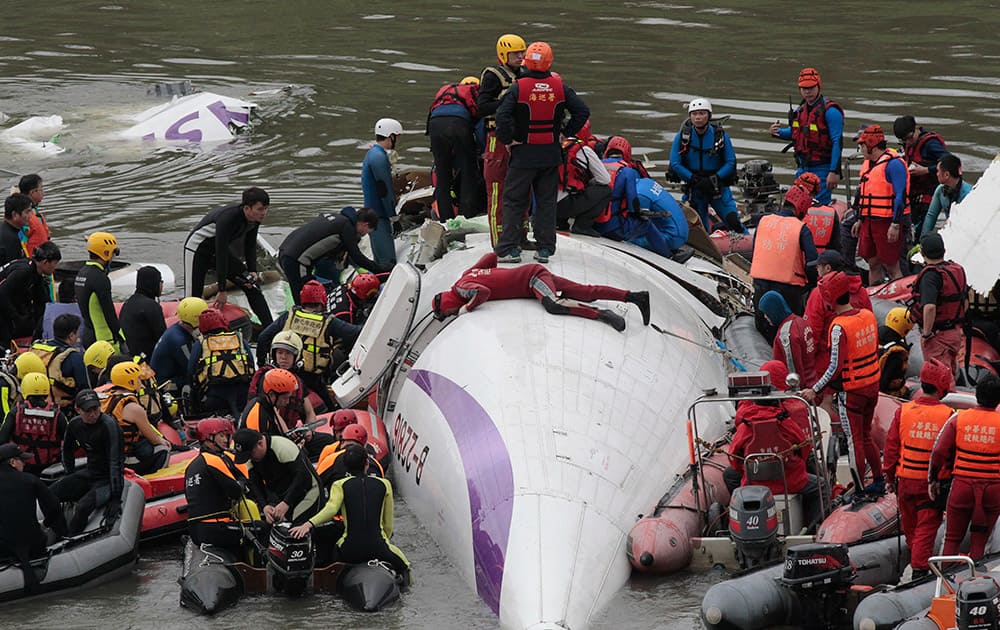 Emergency personnel try to extract passengers from a commercial plane after it crashed in Taipei, Taiwan.