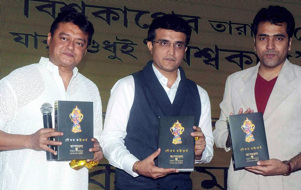 Former Indian cricket team captain Sourav Ganguly release the book Cupmohala- Untlod Dressing Room Stories of author Gautam Bhattacharjee with actors Saswata Chatterjee(L) and Abir Chatterjee.