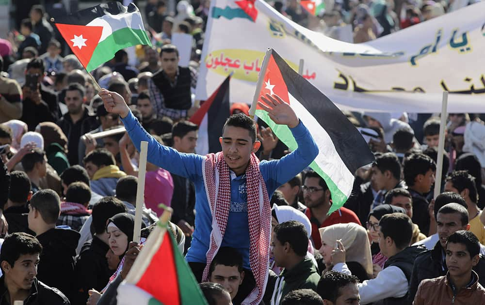 Jordanians chant slogans to show their support for the government against terror during a rally in Amman, Jordan.