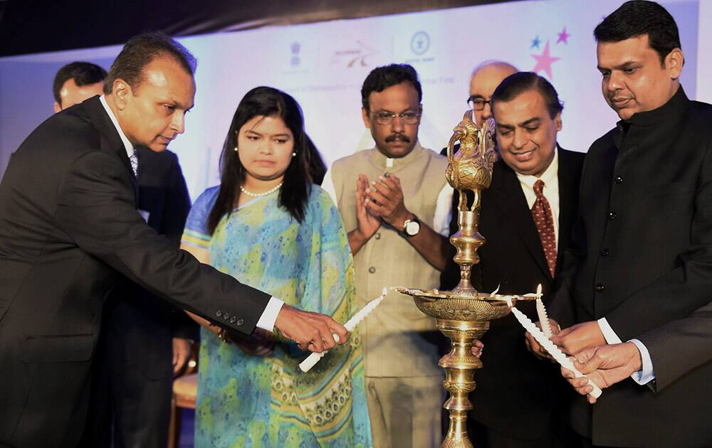 Maharashtra CM Devendra Fadnavis, Reliance Industries Chairman Mukesh Ambani and Reliance ADAG Chairman Anil Ambani light lamps during Mumbai Next Seminar in Mumbai.