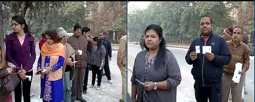 People stand in a queue outside Mayur Vihar polling booth,voting to begin shortly #DelhiVotes. -twitter