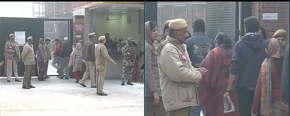 People stand in a queue outside Mayur Vihar polling booth,voting to begin shortly #DelhiVotes -twitter
