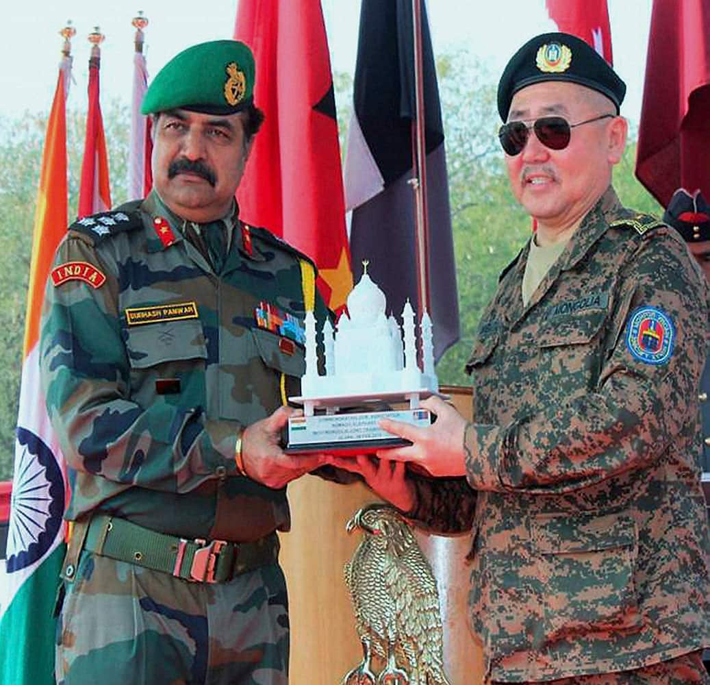 Brig SC Panwar of Indian Army presents a memento to Brig Gen Enkhbaatar of the Mongolian Army at the closing ceremony of the India Mongolia Joint Training Exercise at Gwalior Military Cantonment.