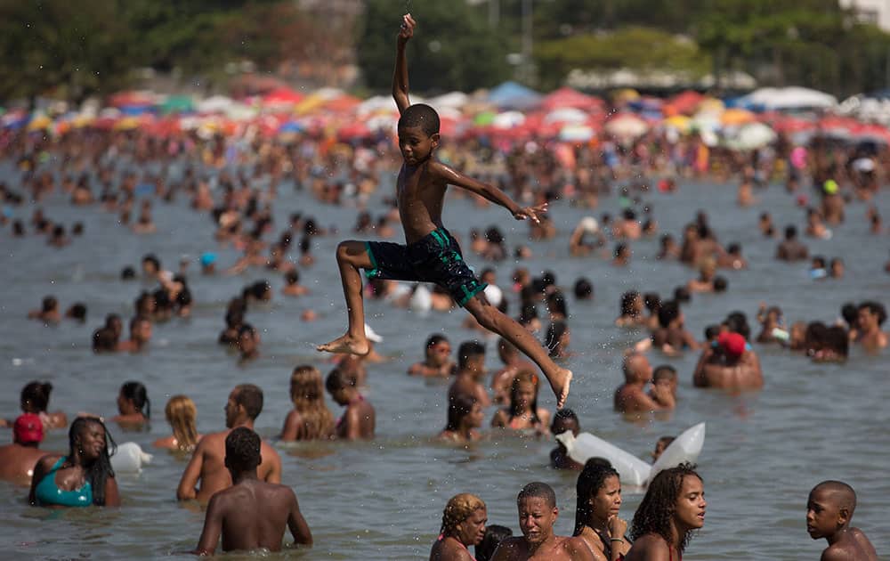  a kid plays at the Piscinao de Ramos artificial beach in Rio de Janeiro, Brazil. In the wake of mass robberies on Ipanema beach, many have opted to beat the heat at this artificial beach on the banks of trash-strewn and polluted Guanabara Bay.
