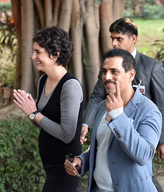 Priyanka Vadra with husband Robert Vadra comes out after casting their votes for Assembly elections in New Delhi.