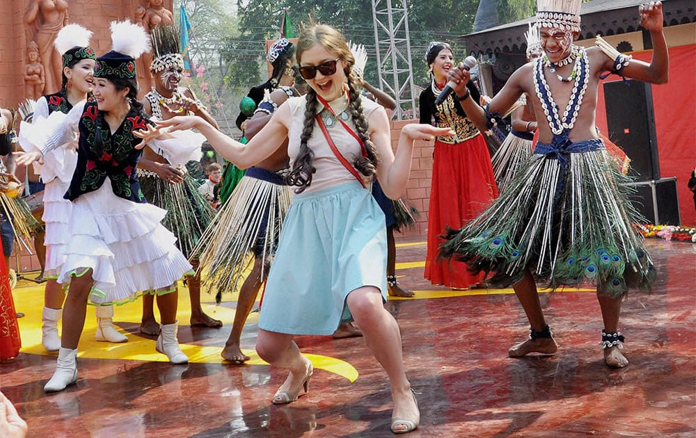 Tourists dance with folk artists at the International Crafts Mela in Faridabad.