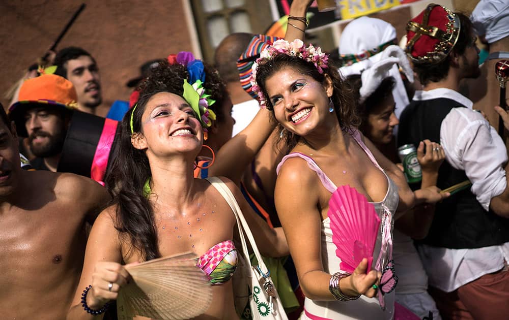 Revelers dance during the 'Ceu na Terra', or Heaven on earth, carnival parade in Rio de Janeiro, Brazil.