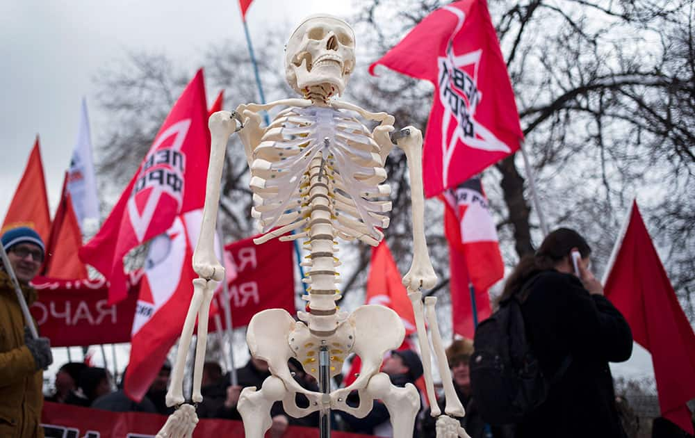 A plastic human skeleton is carried during the Empty Pockets march protesting impoverishment of the people in Moscow, Russia.