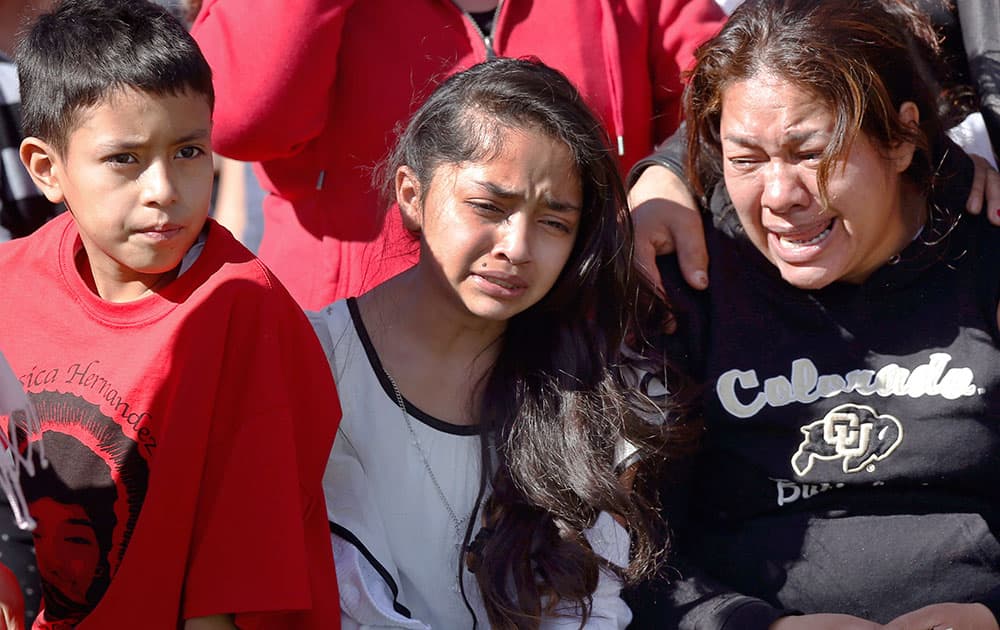 Accompanied by family members, Laura Hernandez, right, weeps during graveside services for her daughter, Jessica Hernandez, in Thornton, Colo. 