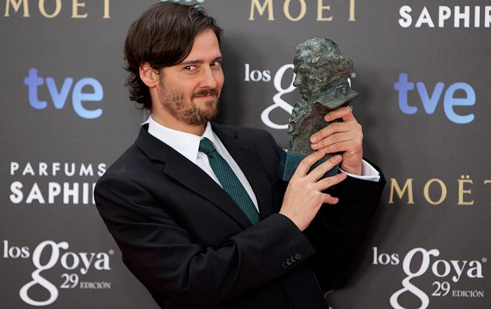 Spanish director Carlos Marques Marcet holds the Goya trophy after winning in best new director for the film 