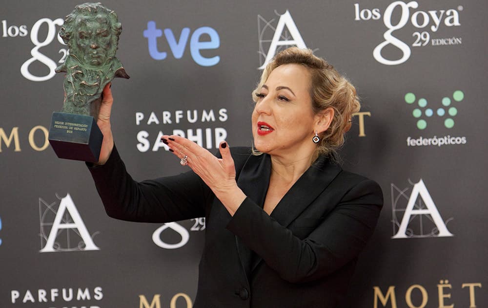 Spanish actress Carmen Machi holds the Goya trophy after winning in the best supporting female actress category in the film 