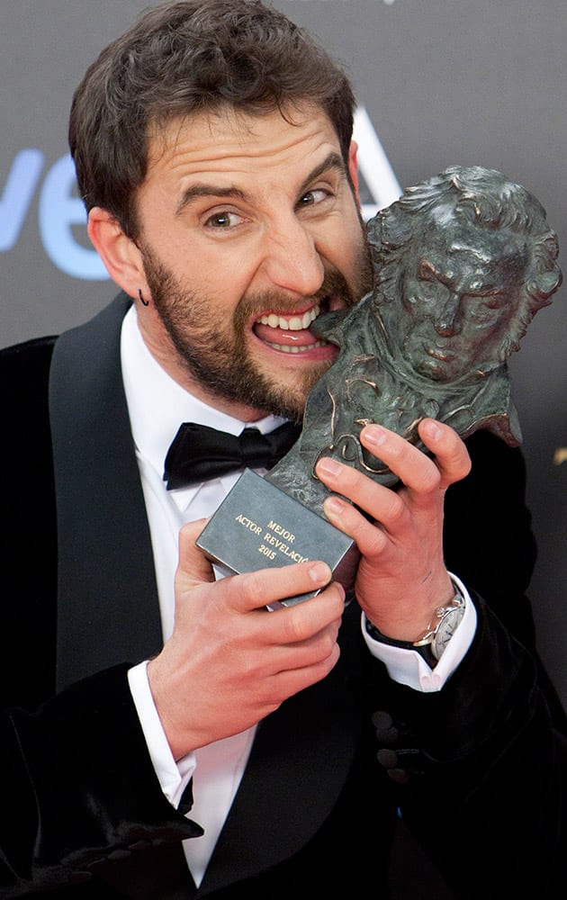 Spanish actor Dani Rovira bites the Goya award trophy after winning the best upcoming male actor category in the film 