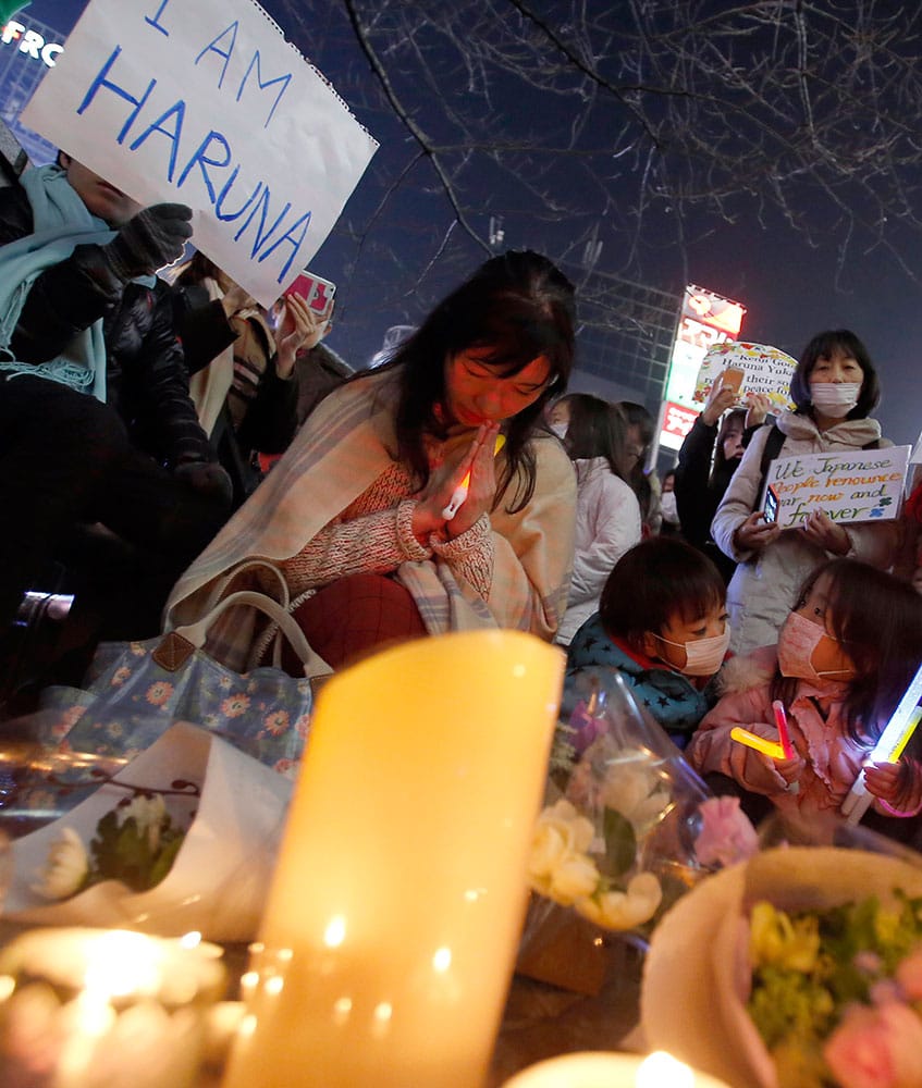 People gather to mourn two Japanese hostages, Kenji Goto and Haruna Yukawa, who were killed by the Islamic State group, in Tokyo