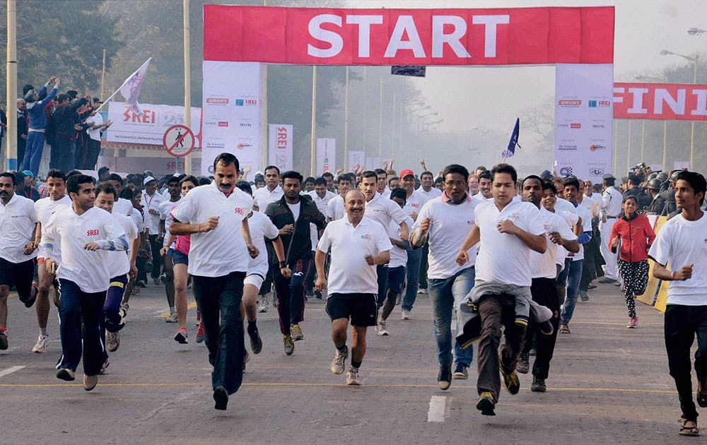 Participants run during the Kolkata Marathon 2015 in Kolkata.