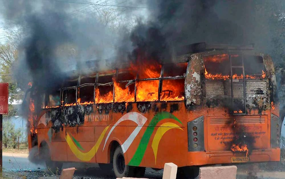 A bus set on fire by an angry mob after a boy was crushed to death by the bus in Mathura. 