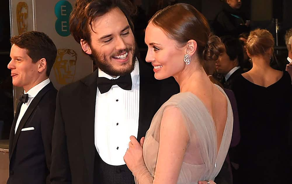 Sam Claflin, left and Laura Haddock arrive for the British Academy Film and Television Awards 2015, at the Royal Opera House, in London.