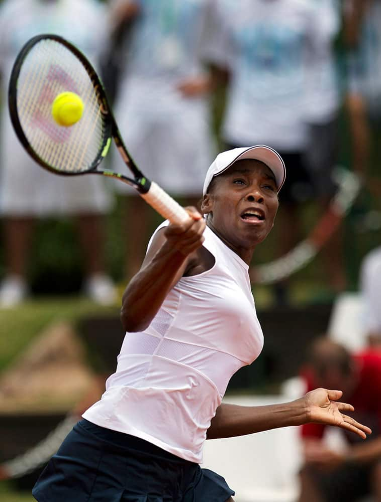 Venus Williams of the United States returns a shot to Maria Irigoyen of Argentina, in the Fed Cup World Group II first round women's singles tennis match, in Buenos Aires, Argentina.