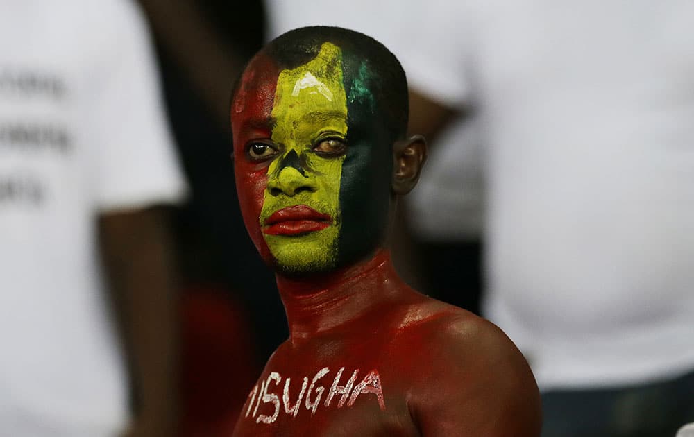 Ghana soccer fan with face painted in his country national colours reacts after his team lost their African Cup of Nations final soccer match to Ivory Coast in Bata, Equatorial Guinea.