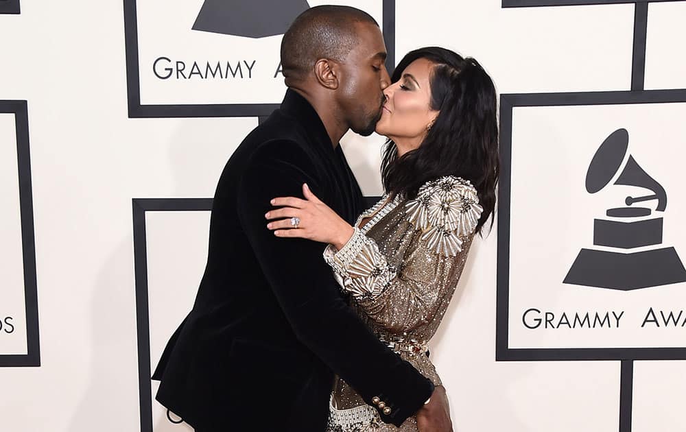 Kanye West and Kim Kardashian arrive at the 57th annual Grammy Awards.