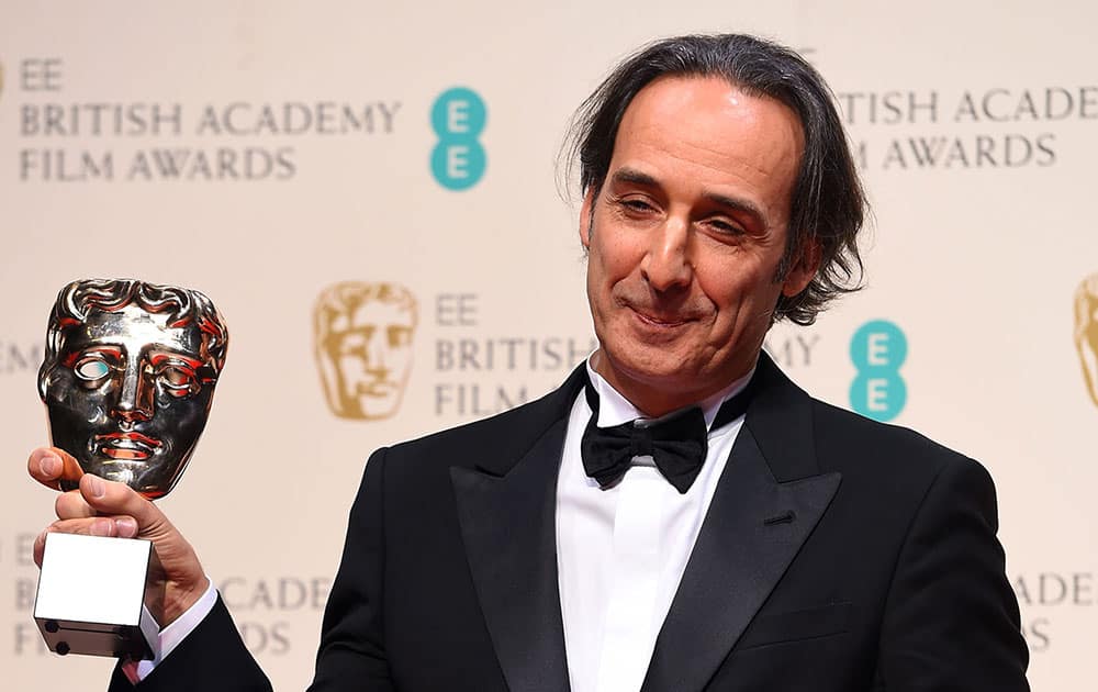 Alexandre Desplat, winner of Best Original Music for The Grand Budapest Hotel poses for photographers in the winners room, during the British Academy Film and Television Awards 2015.