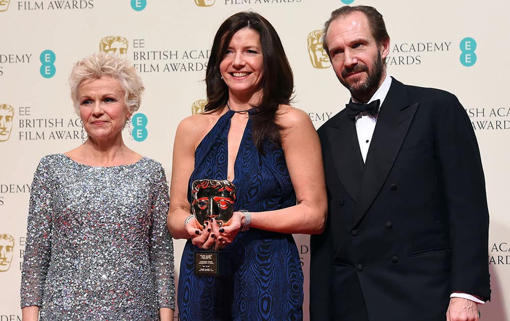 Julie Walters, left and Ralph Fiennes, right, pose with Christine Langan, winner of Outstanding Contribution to British Film for The BBC, in the winners room, during the British Academy Film and Television Awards 2015.