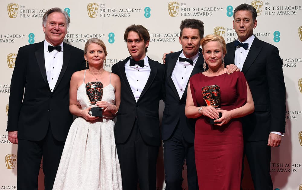 Cast and crew members from the winner of the Best Film Award, Boyhood, pose for photographers, in the winners room, during the British Academy Film and Television Awards 2015.