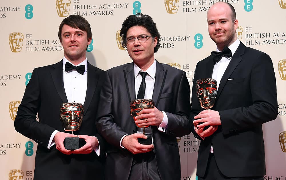 From left, Brian J. Falconer, Ronan Blaney and Michael Lennox, winners of the Best Short film, Boogaloo and Graham, pose for photographers in the winners room, during the British Academy Film and Television Awards 2015.