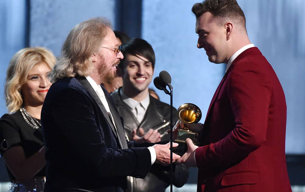 Barry Gibb, left, present the award for best pop vocal album to Sam Smith for “In the Lonely Hour” at the 57th annual Grammy Awards.